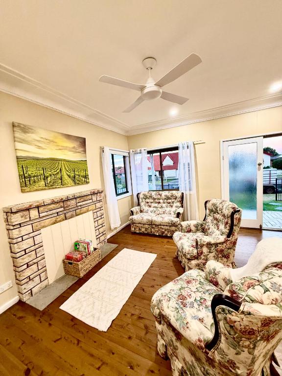 a living room with a couch and a fireplace at Ferguson House in Cessnock