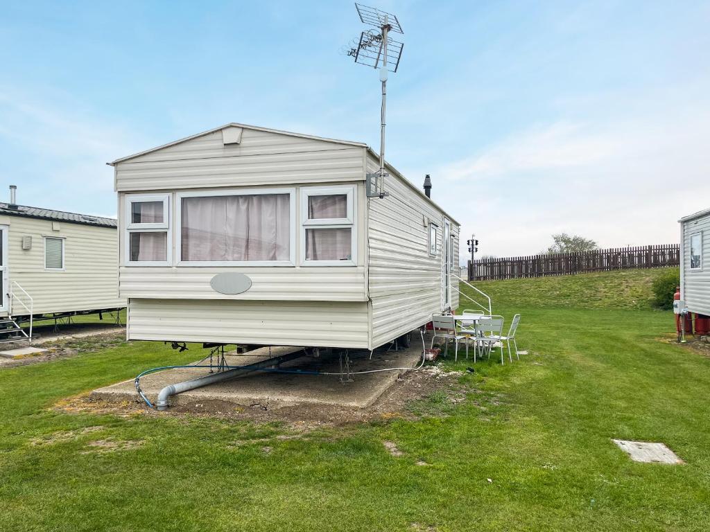 a tiny house on a trailer in a yard at Joys in Jaywick Sands