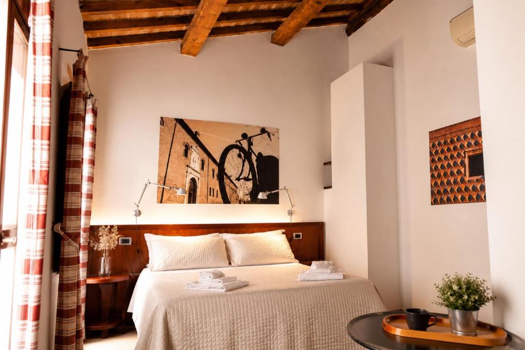 a bedroom with a bed and a bike on the wall at Boutique Rooms 3 0 in Ferrara