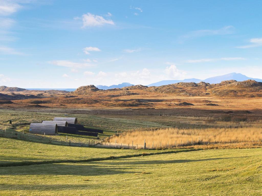 a field with a building in the middle of a field at Katie's Pod in Acharacle