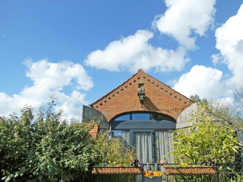 a house with a brick roof and a window at Bert's Barn in Firsby