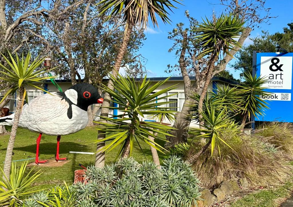 a statue of a bird in front of a building at & Art Motel in Tootgarook