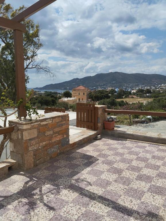 a patio with a fence and a view of a building at Gaia in Posidhonía