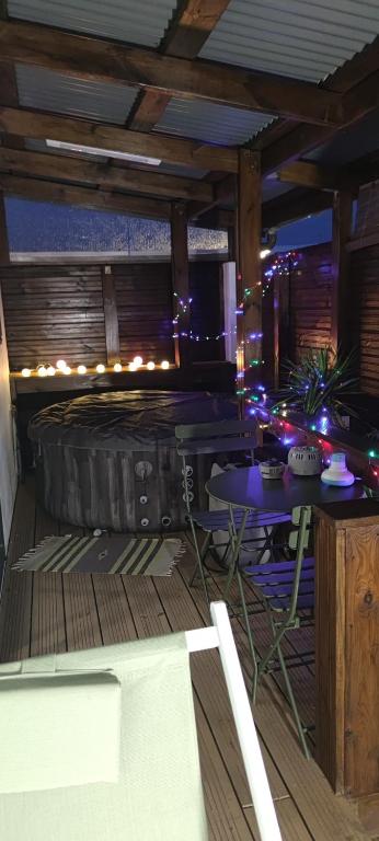 a room with a large tire on a deck with lights at Fleur de Vanille in Saint-Philippe