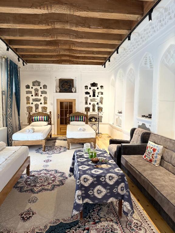 a living room with two couches and a table at Barlos Boutique XVIII in Bukhara