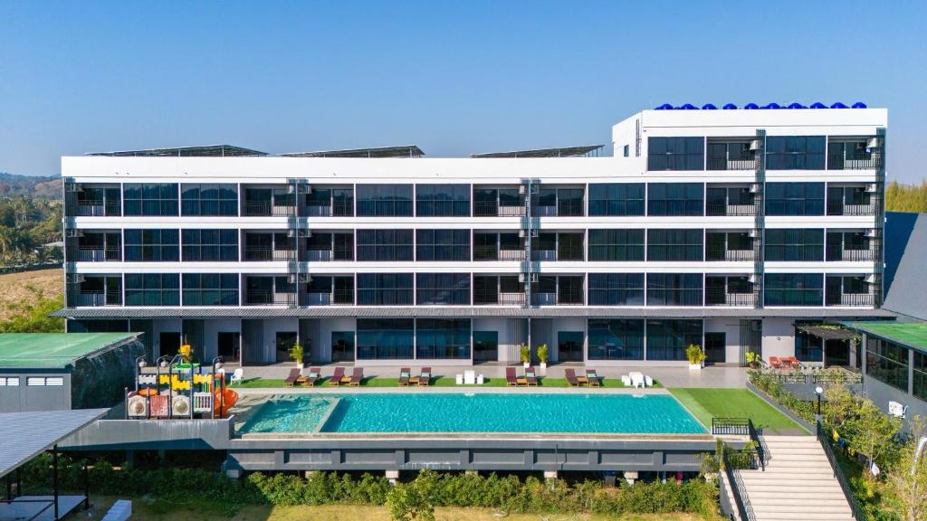 an external view of a building with a swimming pool at GrandWara Khao Yai แกรนด์วารา เขาใหญ่ in Ban Nong Song Hong