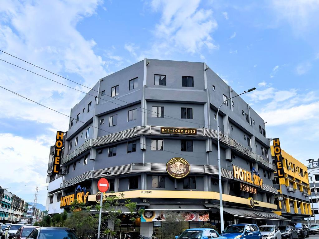 a tall gray building with a sign on it at Sky Hotel Cheras Maluri in Kuala Lumpur
