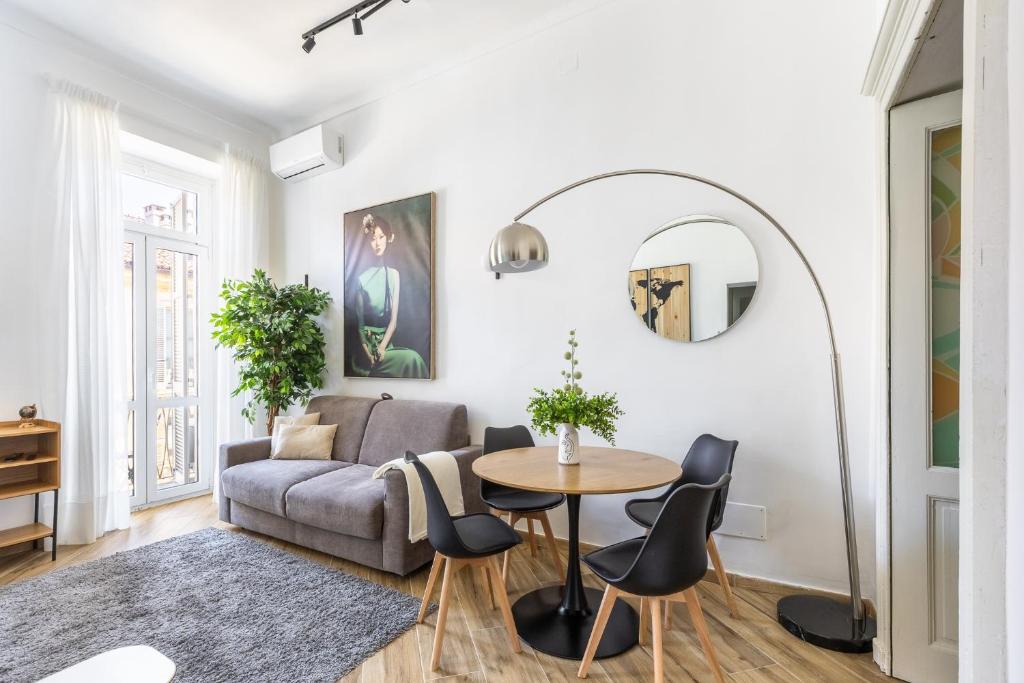 a living room with a couch and a table at Le Monde Luxury Apartment in Turin