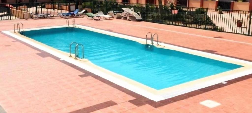 a large swimming pool with two metal handles in it at Bella in Parque Holandes