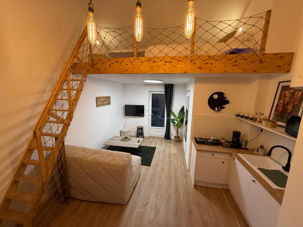 a living room and kitchen with a loft bed at suite Jacuzzi terrasse privé parking in Caligny