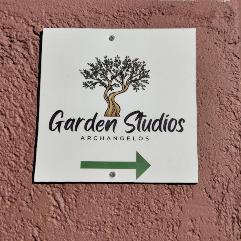 a sign for a garden studio with a tree on a wall at Garden Studios N3 in Archangelos
