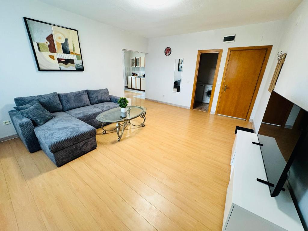 a living room with a couch and a glass table at Apartment Nencheva in Sandanski