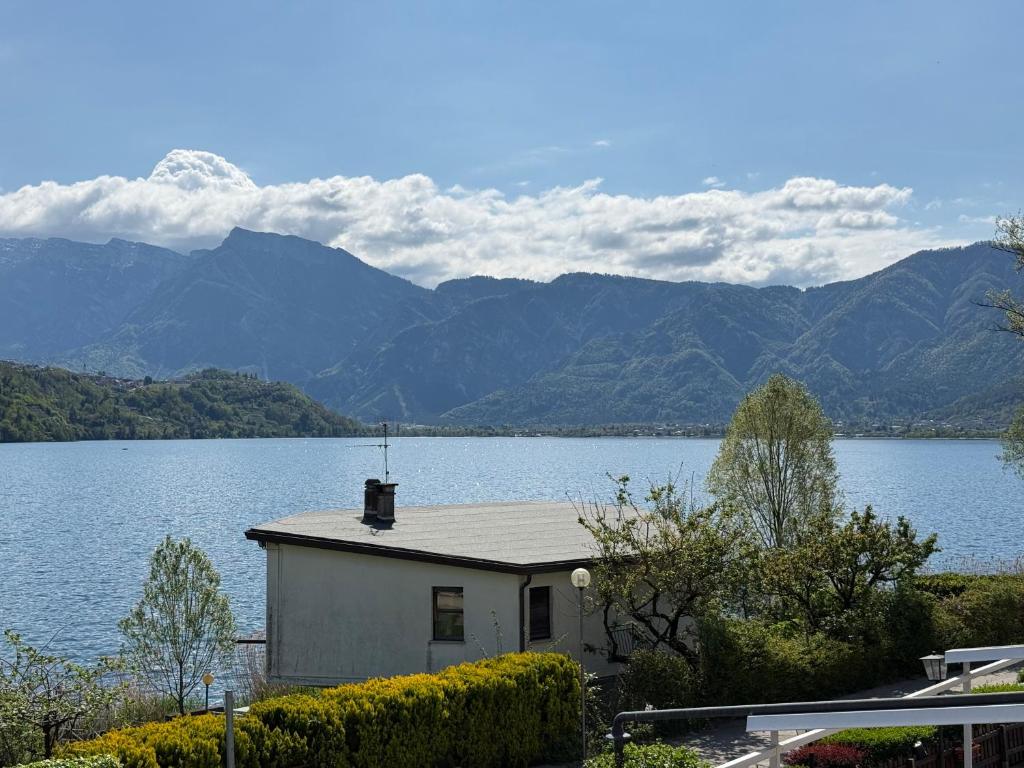 a house on the shore of a large body of water at Albergo Mezzolago in Calceranica al Lago
