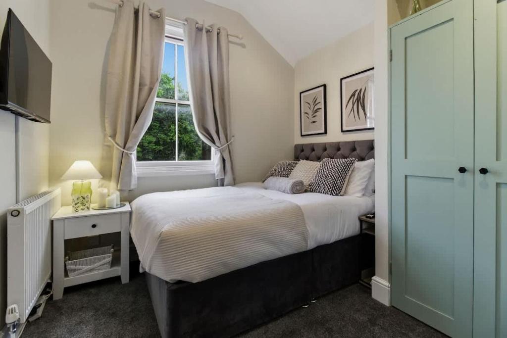 a bedroom with a large bed and a window at Riverside Crossing in Worcester
