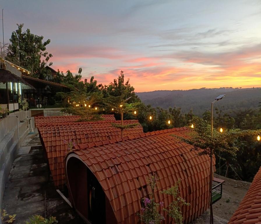 a roof of a building with a sunset in the background at Cozzy Bitu Garden in Bunder