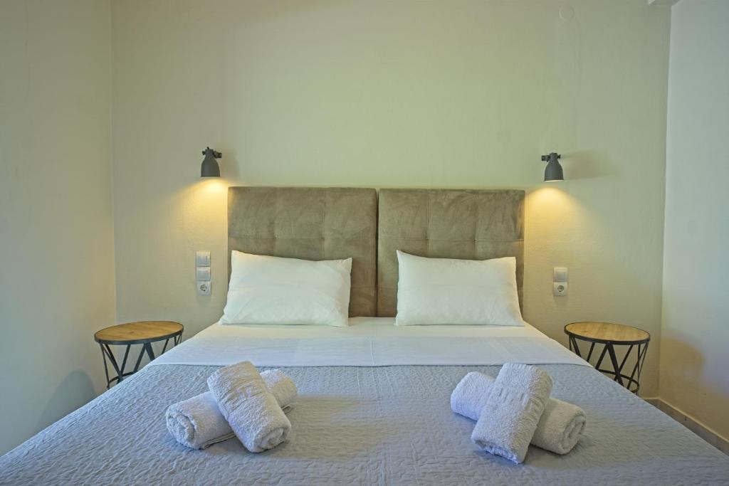 a bedroom with a bed with two towels on it at Dimitra Apartments in Kanali