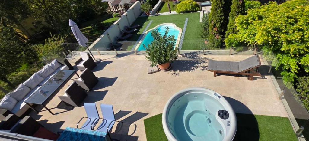 an overhead view of a backyard with a bath tub at White villa in Esztergom