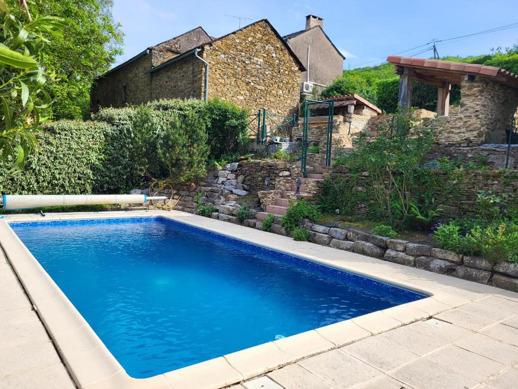 a swimming pool in front of a house at Anaky rider nomade in Curvalle