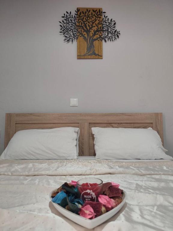 a tray of clothes on a bed with a plate on it at Garden studio N4 in Archangelos