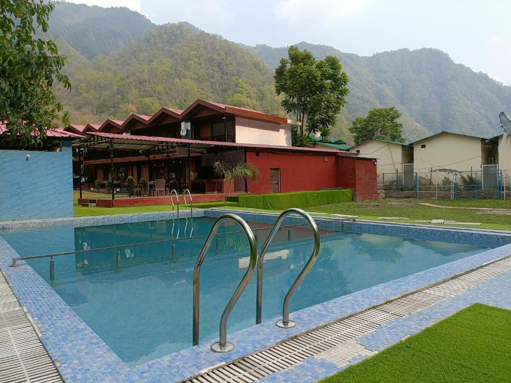 a large swimming pool in front of a building at Aqua Forest River Resort in Bijni
