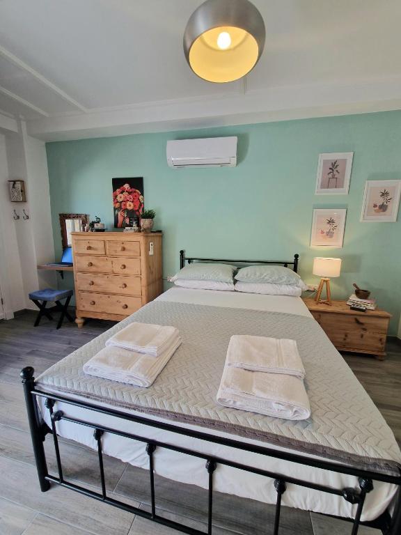 a bedroom with a bed with two towels on it at Xenia Studios in Piskokéfalon