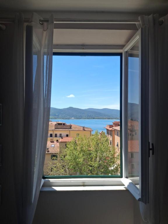 a window with a view of the water at Casa Azzurra in Portoferraio
