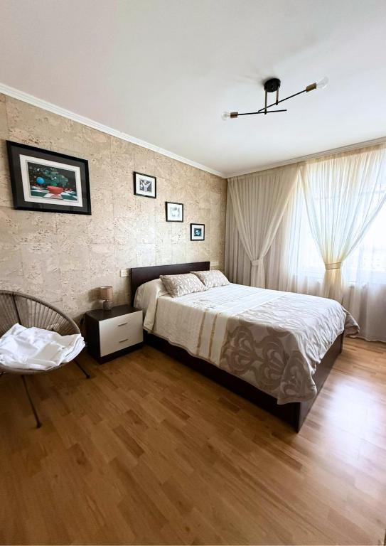 a bedroom with a bed and a chair at Casa Ramona en Foz in Foz