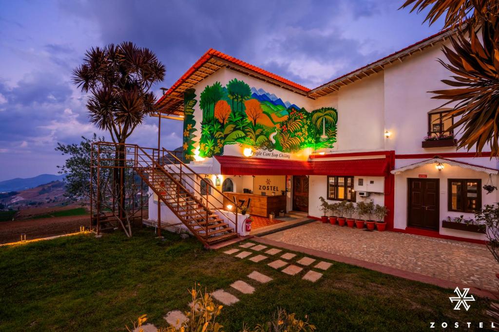 a house with a mural on the side of it at Zostel Ooty, Pudumund in Ooty