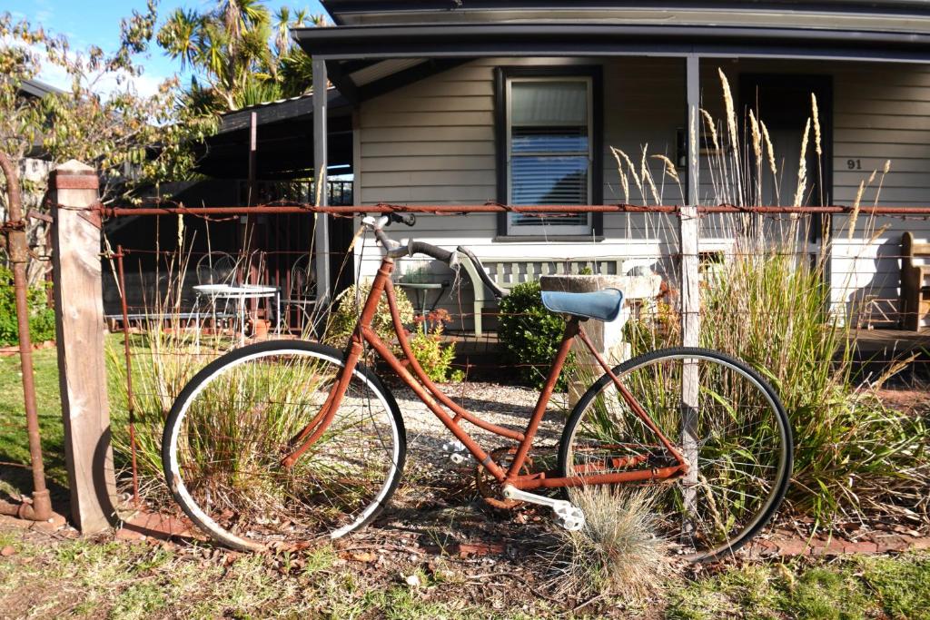 an orange bike parked in front of a house at Homesaway Cottage in Kyneton