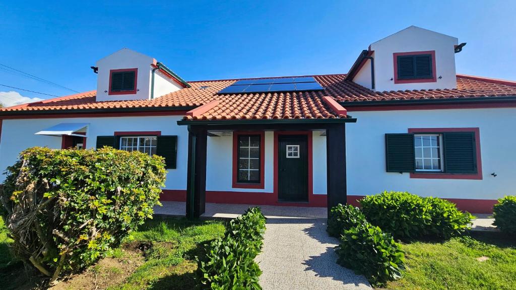 a house with solar panels on the roof at Cimo das Dutras in Horta