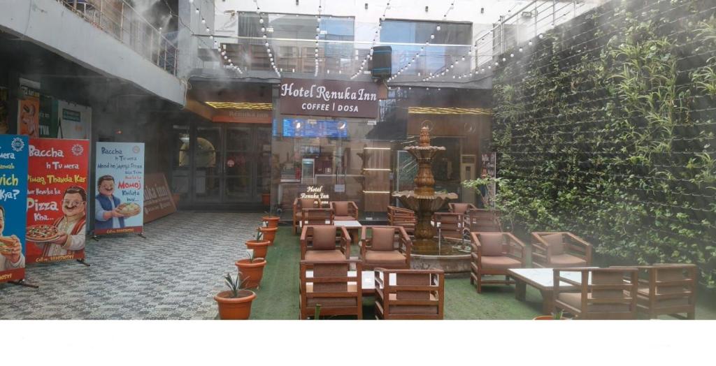 a room with chairs and tables in a building at Hotel Renuka Inn A Unite shyam ganga builders in Deoria
