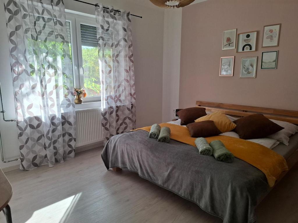 a large bed in a bedroom with a window at Vidam in Csengőd
