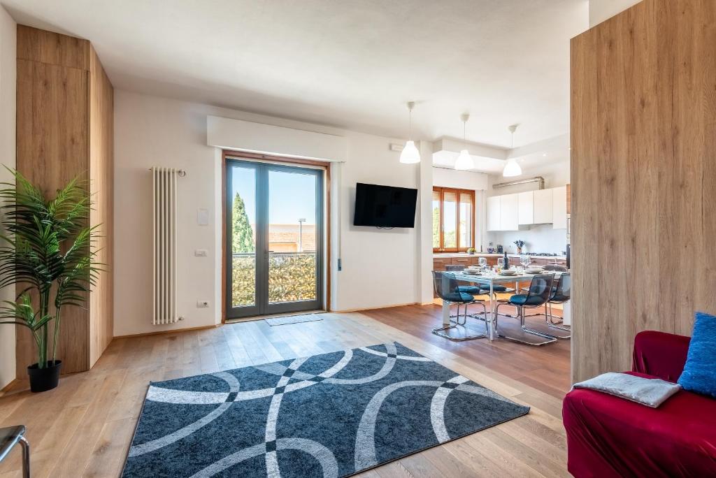 a living room with a red couch and a table at Appartamento BePlace - Le Crete in Rapolano Terme