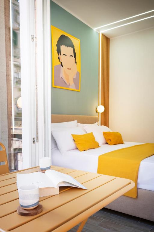 a bedroom with a bed and a table with a desk at N'Ador Rooms in Naples
