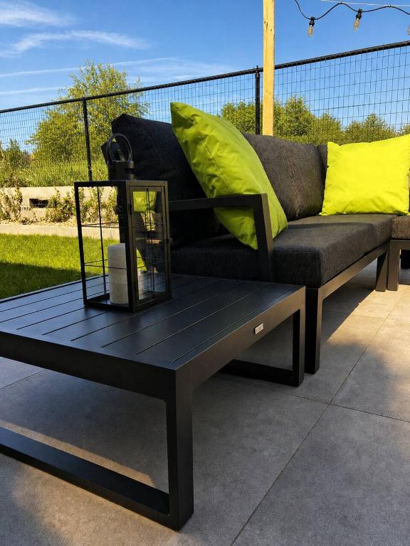 a black coffee table with a couch on a patio at Obobonne in Geraardsbergen