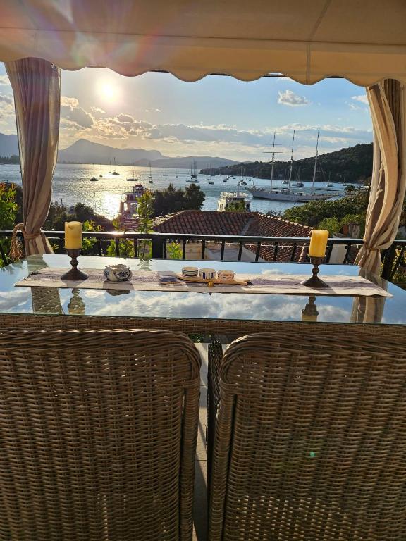 a table with chairs and a view of the water at Archontikon 1800 in Poros