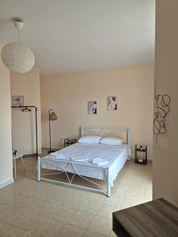 a bedroom with a white bed in a room at Airport city center 2 in Spata