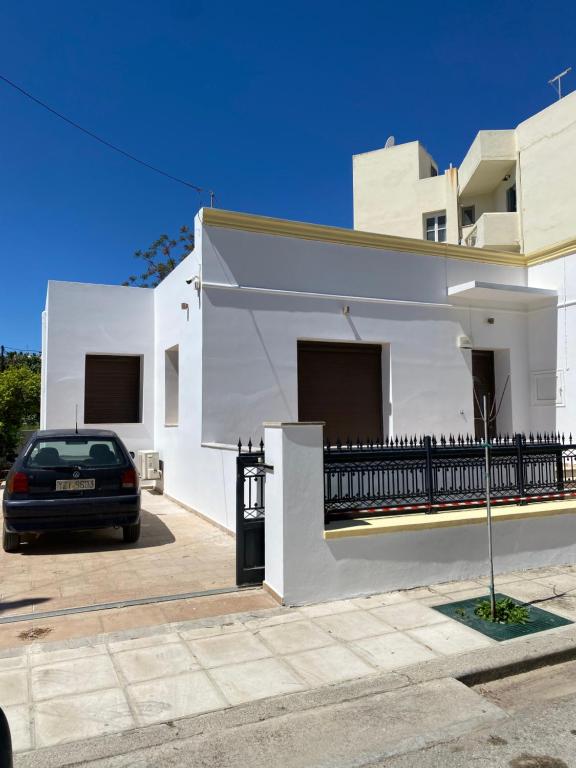 a car parked in front of a white house at CasaKOS in Kos