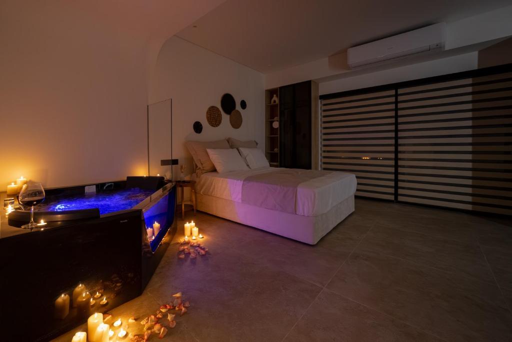a bedroom with a bed and a fireplace at Andromeda Suite Private Jacuzzi & Cave Shower in Athens