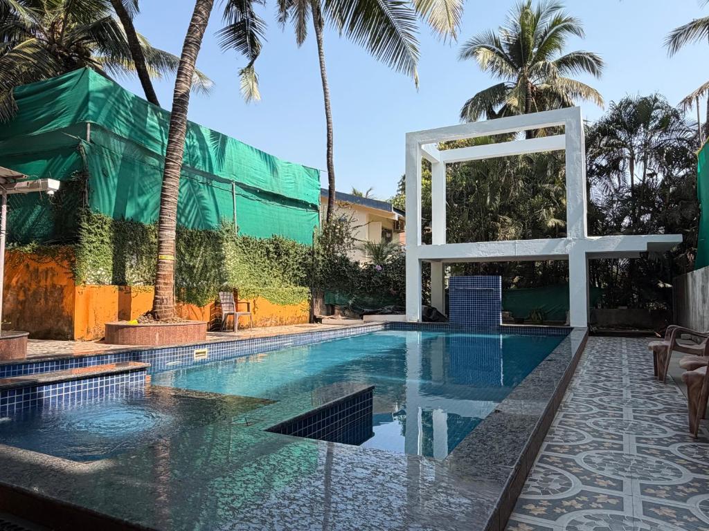 a large swimming pool with a cross in the middle at Aura Calangute in Calangute