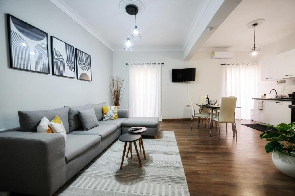 a living room with a couch and a table at Patithries Apartments in Kalymnos