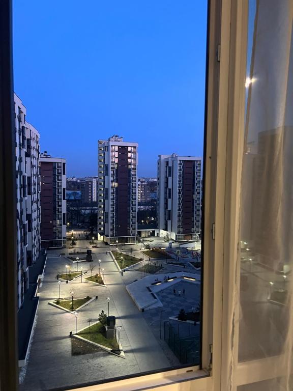 a view of a city from a window at Manhattan Comfort in Ivano-Frankivsk