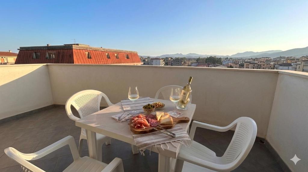 a white table and chairs on a balcony with a view at Casa Angela in Olbia