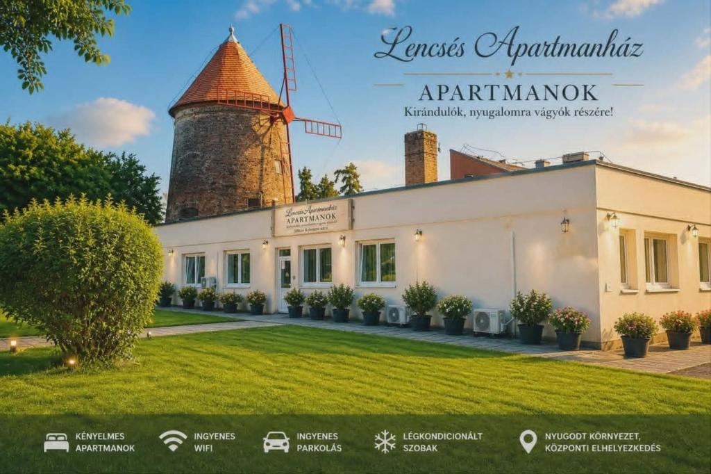 a picture of a building with a windmill at Lencsés Apartmanház Apartmanok in Sopron