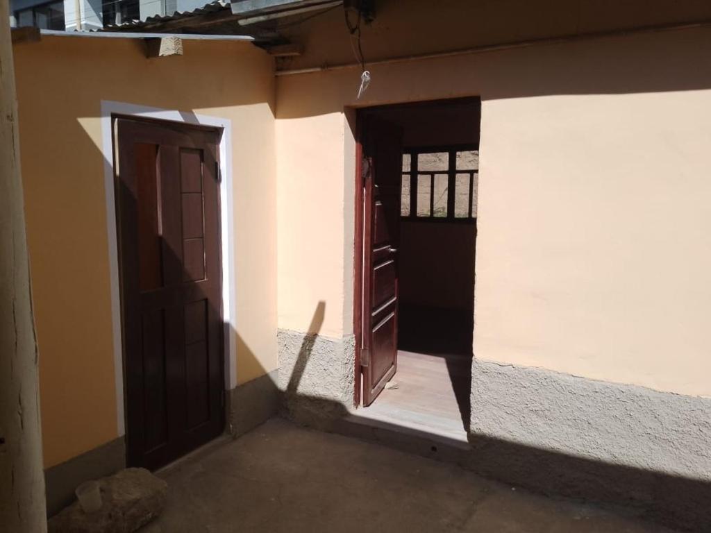 two doors on the side of a building at Casa Oruro Valvic in Oruro