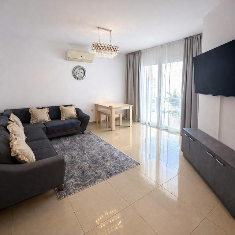 a living room with a couch and a table at Lapta SEL in Ayios Dhometios