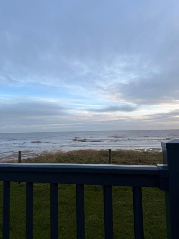 a view of the ocean from a balcony at Sea View Static Caravan With Decking - Skipsea Sands Holiday Park in Skipsea