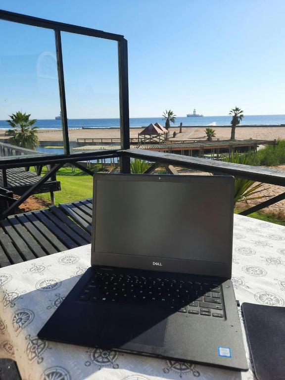 a laptop computer sitting on a table near the beach at Lalandi 14 - Beachfront Self-Catering- Langstrand Walvis Bay in Langstrand