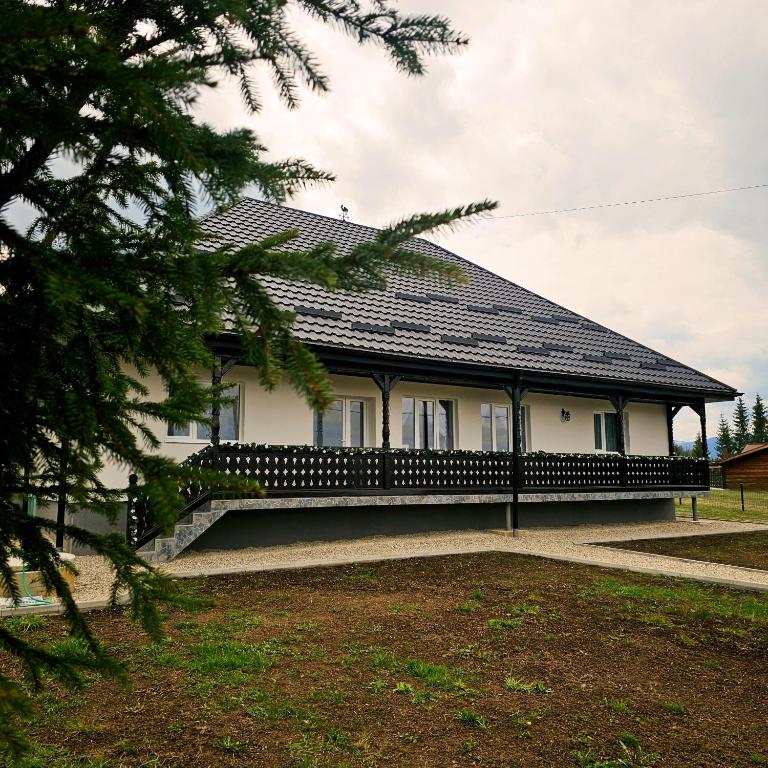 a white house with a black roof at Belvedere Panaci in Coverca