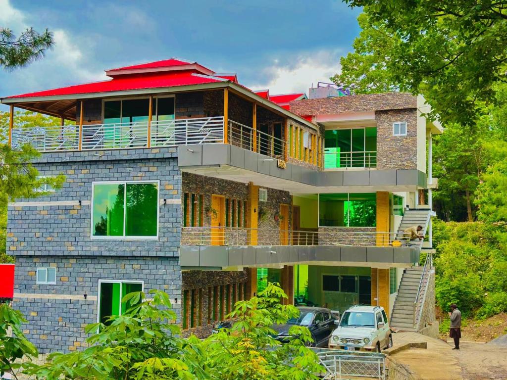 a brick house with a red roof at Pine Peaks Heaven in Nathia Gali